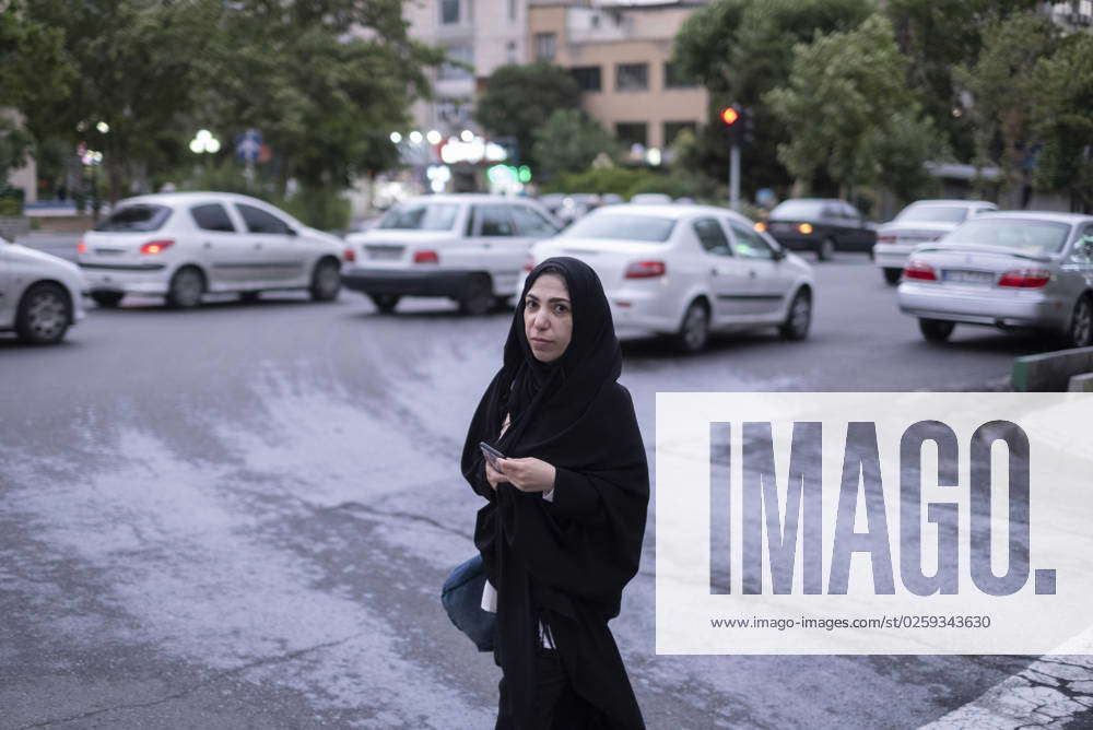 Daily Life In Iran A Veiled Iranian Woman Crosses A Street In Downtown