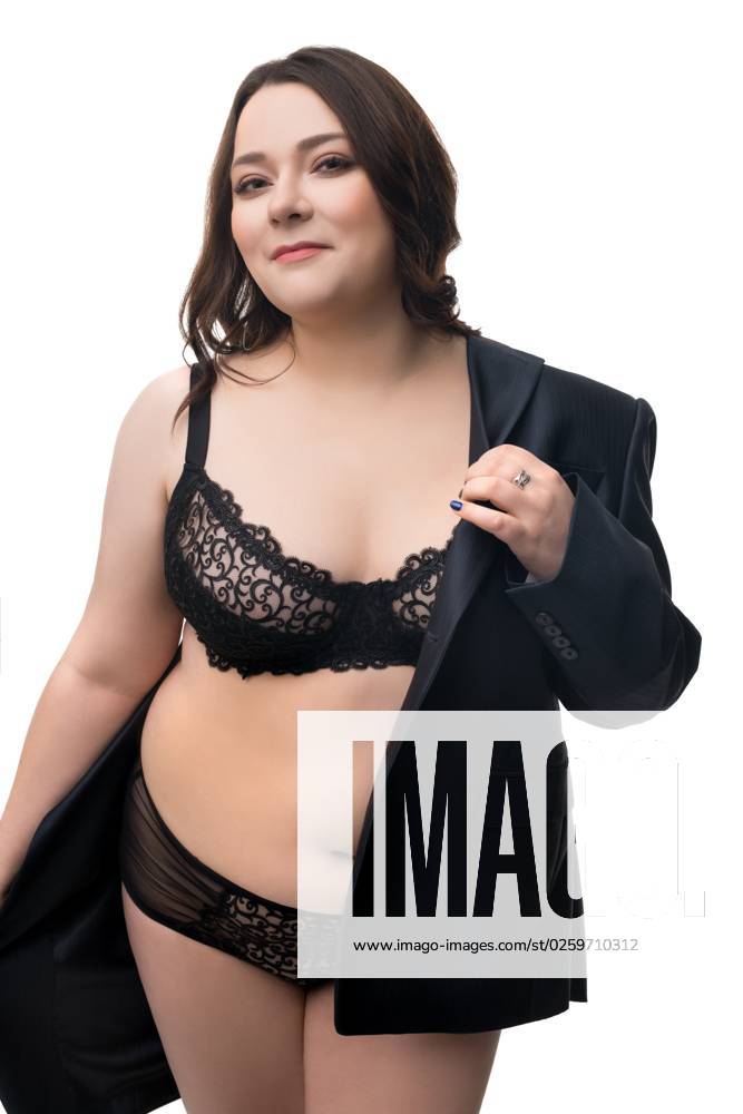 Coquettish overweight lady in lingerie and jacket Smiling plus