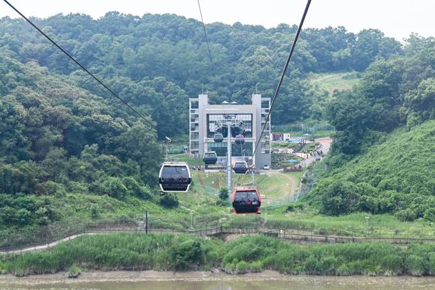 Cable cars on the Imjingak Peace Gondola cross over the Imjingak River ...