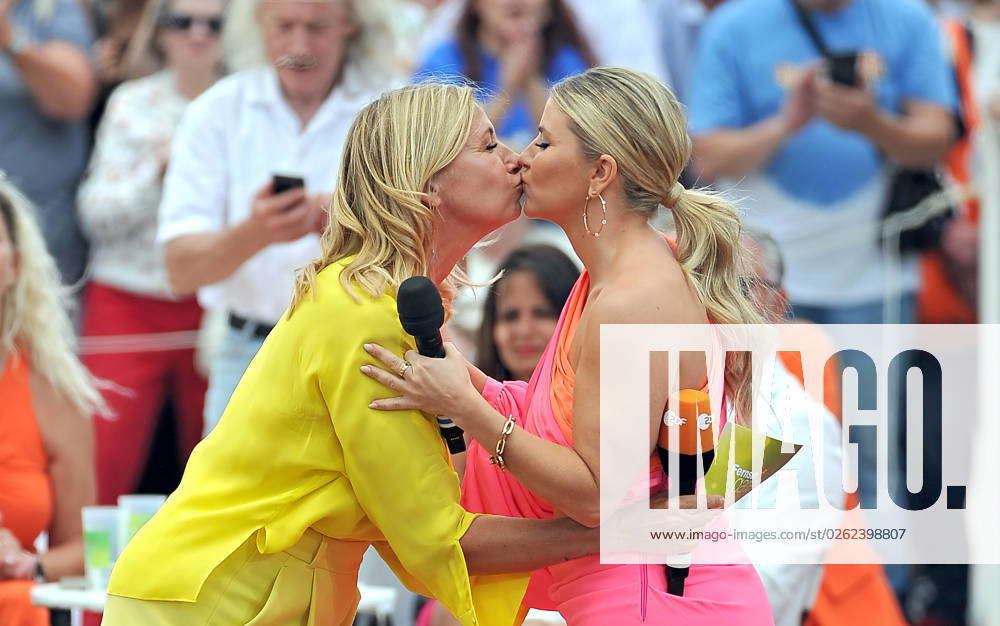 ZDF Fernsehgarten host Andrea Kiwi Kiewel kisses singer Beatrice