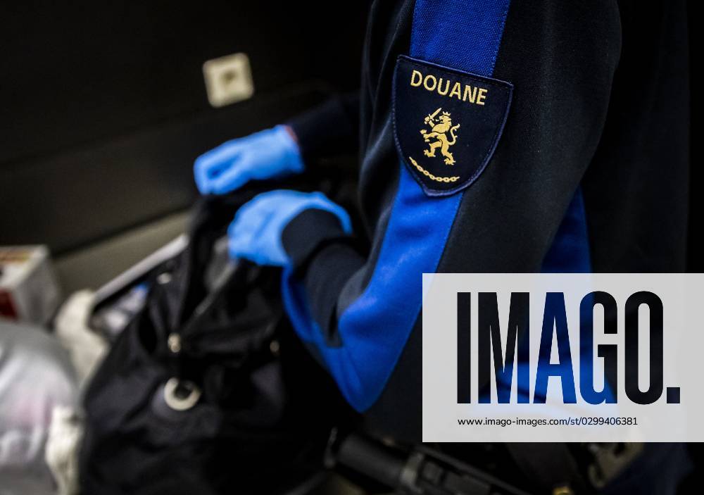 SCHIPHOL - A Customs Officer Inspects A Suitcase At Schiphol Airport ...