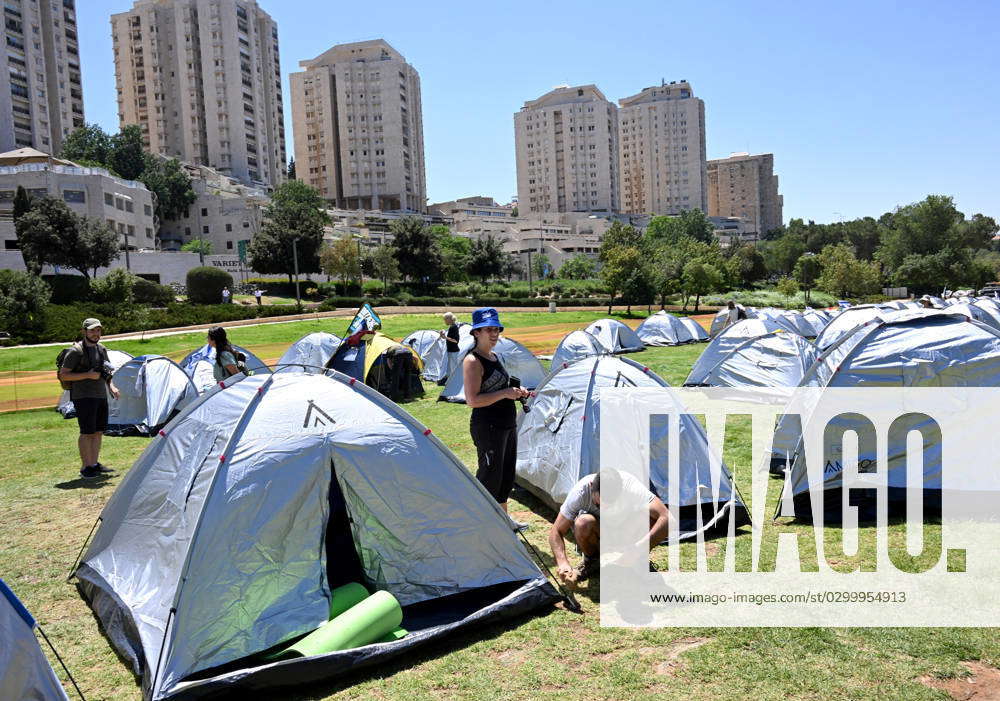 Israelis secure their tent in an encampment set up by anti-government ...