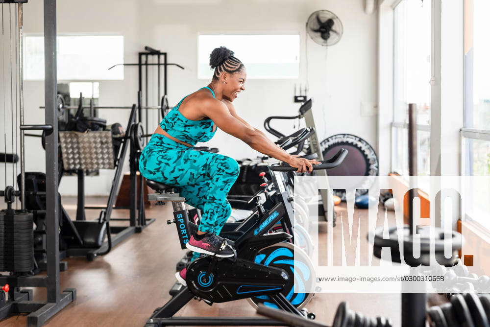 Pretty girl doing exercise on an exercise bike. crossfit gym. Cycling Valenca Bahia Brazil