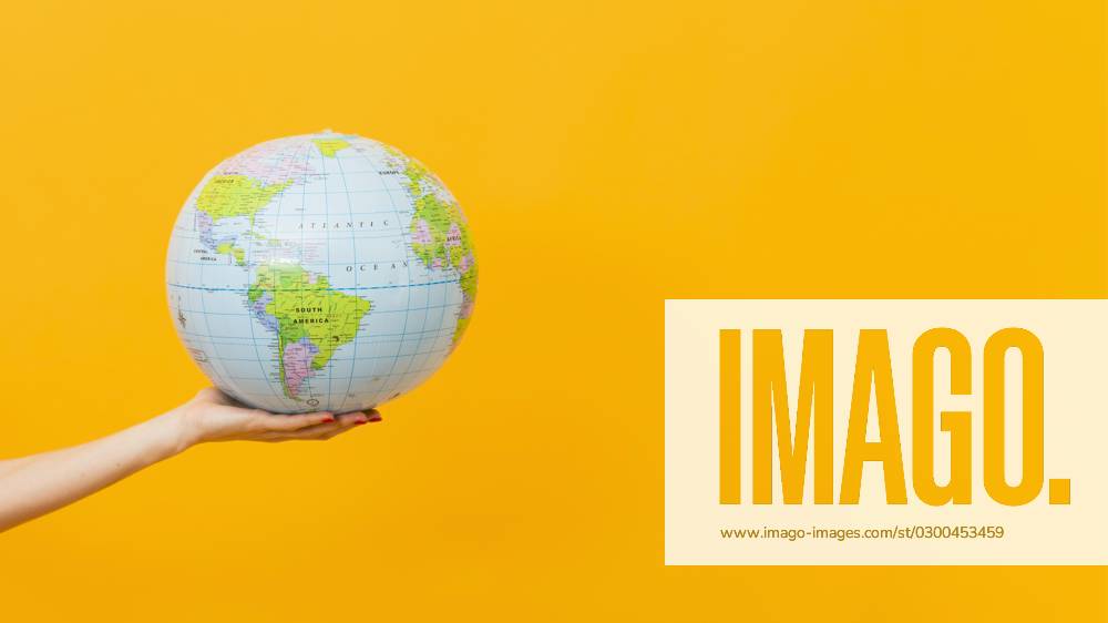 Side view Hand holds Erdglobus with Copy Room Photo with high Resolution