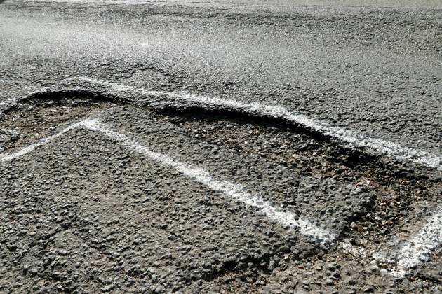 Daily life, potholes Potholes along the country lanes are spray painted ...