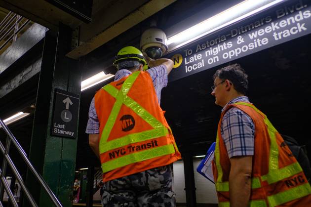 July 30, 2023, New York, New York, USA: MTA workers install a ...