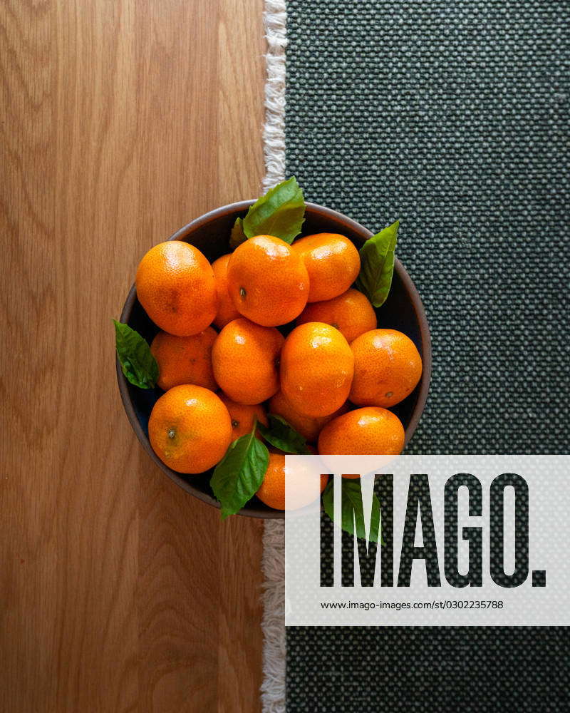 a-bowl-of-oranges-sitting-on-a-wood-kitchen-table-louisa-virginia