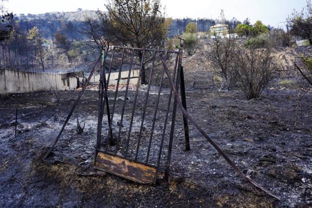 Wildfire On Mount Parnitha In Athens The door from the yard of a house ...