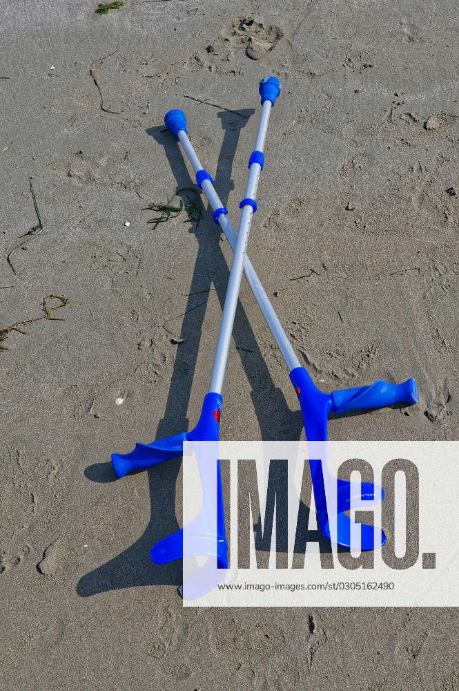 Finally swimming discarded crutches lying on the beach Cavallino Veneto