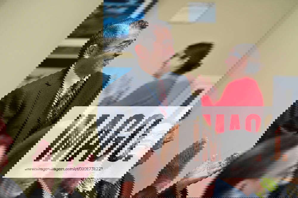 Edwin Oshiba stands to acknowledge Dr. Ravi Chaudhary, assistant