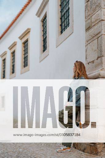 a-vertical-shot-of-a-female-in-a-typical-street-in-lagos-portugal