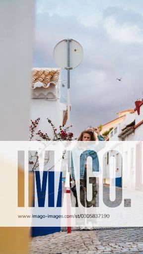 A Vertical Shot Of A Female In A Typical Street In Lagos Portugal a-vertical-shot-of-a-female-in-a-typical-street-in-lagos-portugal