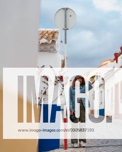 a-vertical-shot-of-a-female-in-a-typical-street-in-lagos-portugal