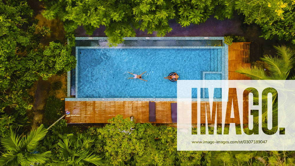 Couple men and woman in swimming pool in the jungle of Krabi Thailand ...