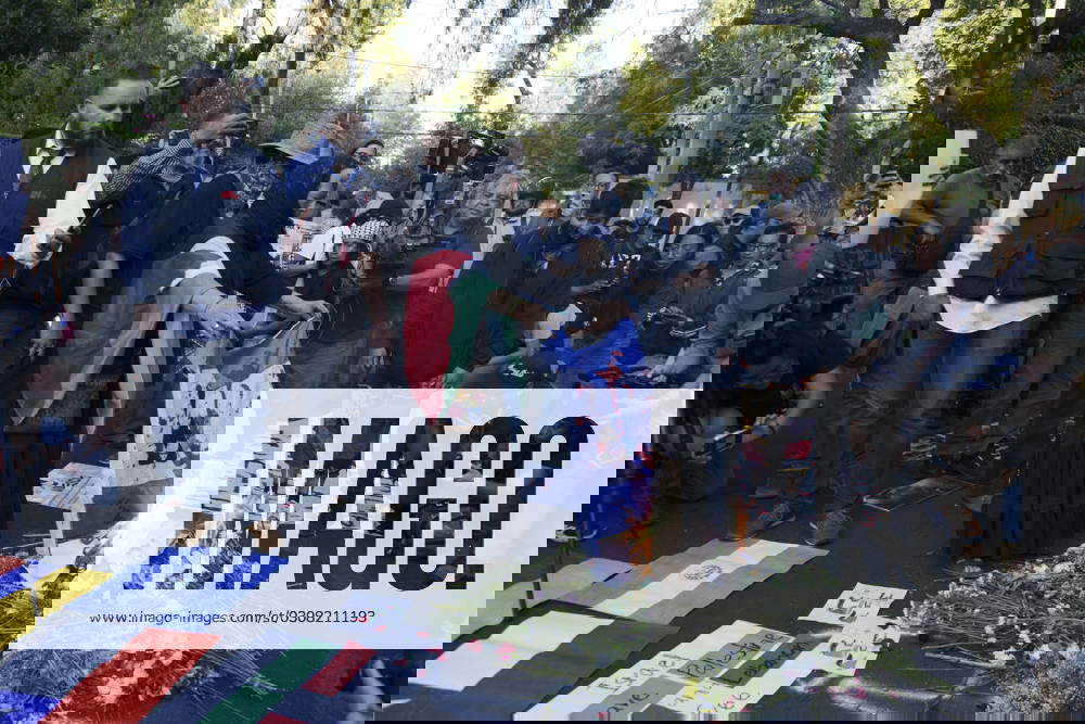A woman burns Israel flag during a rally outside the Israeli Embassy in