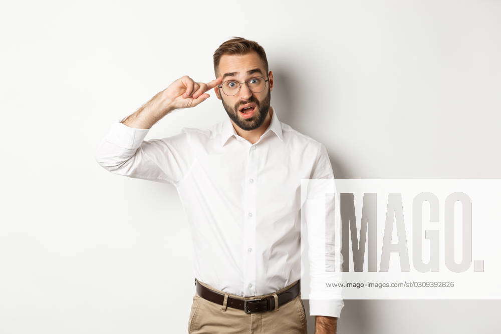 Confused man pointing at head, scolding employee, reaction on something ...