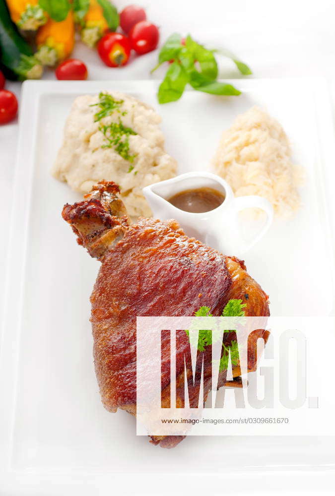 Original German Bbq Pork Knuckle Served With Mashed Potatoes And Sauerkraut Fresh Vegetables On