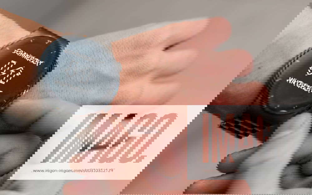Augsburg, Bavaria, Germany 25 October 2023 A man changes his smartwatch wristwatch from daylight