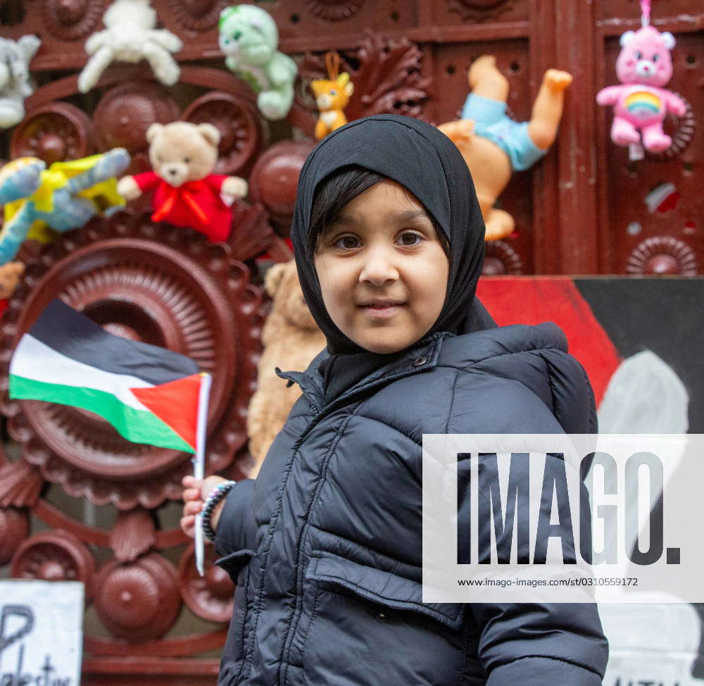 October 27, 2023, London, England, United Kingdom: Children place teddy ...