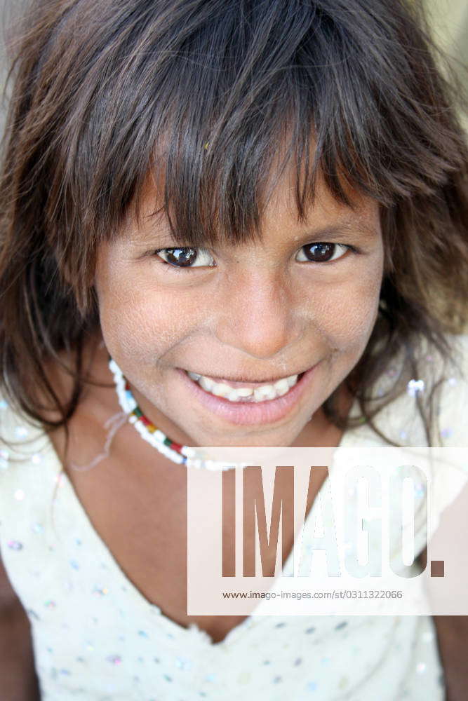 A portrait of a poor Indian beggar girl with a cute smile., model ...