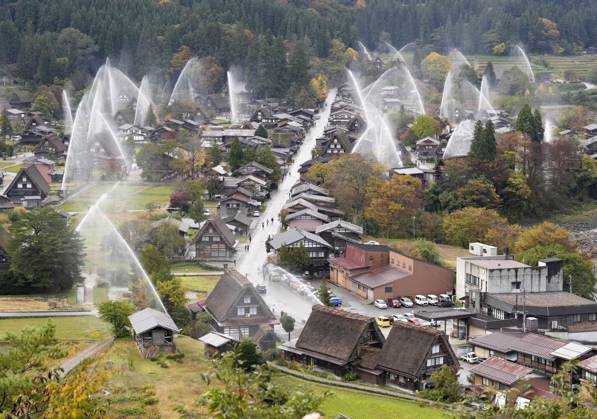 Water spray drill at Shirakawa-go Jets of water are sprayed over ...