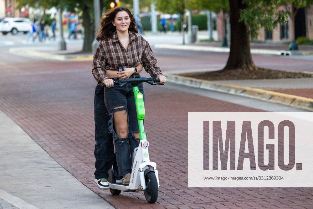 Syndication The Oklahoman Two people ride an E Scooter in Downtown