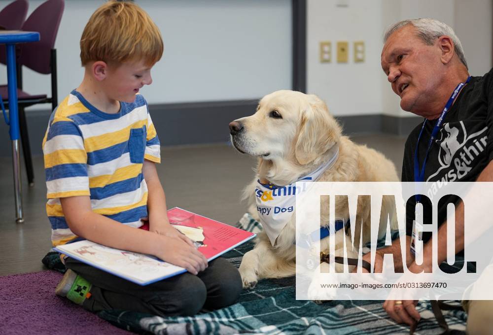 Syndication The Indianapolis Star PJ Kelly, 8, reads to Paws and Think therapy dog Cooper and