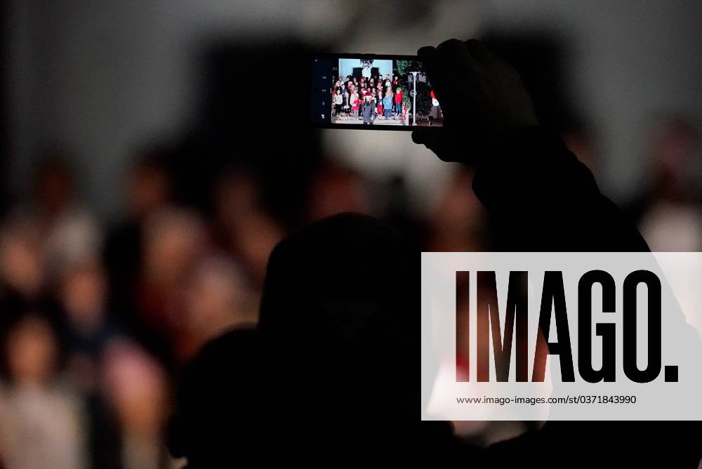 Syndication Tuscaloosa News A person shoots video of students from