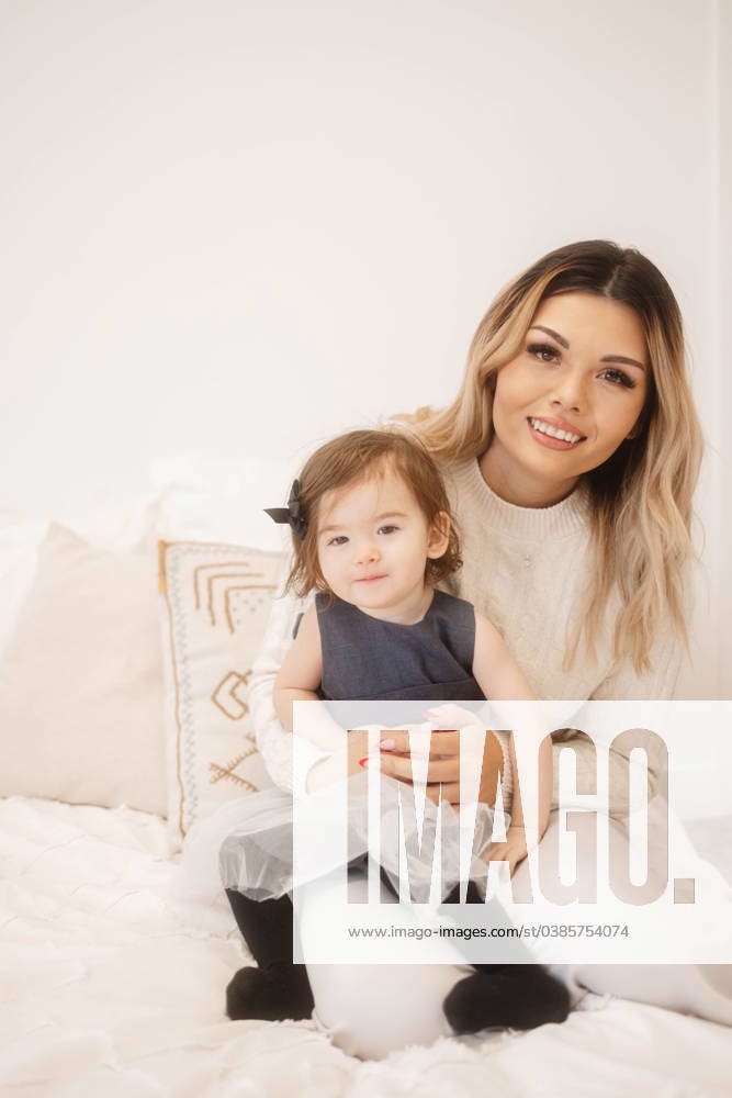Happy Toddler Daughter and Mother Portrait on a Bed Edmonton, Alberta