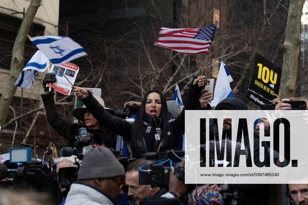 January 12 2024 Manhattan Ny United States A Woman Waves Flags Of   M 