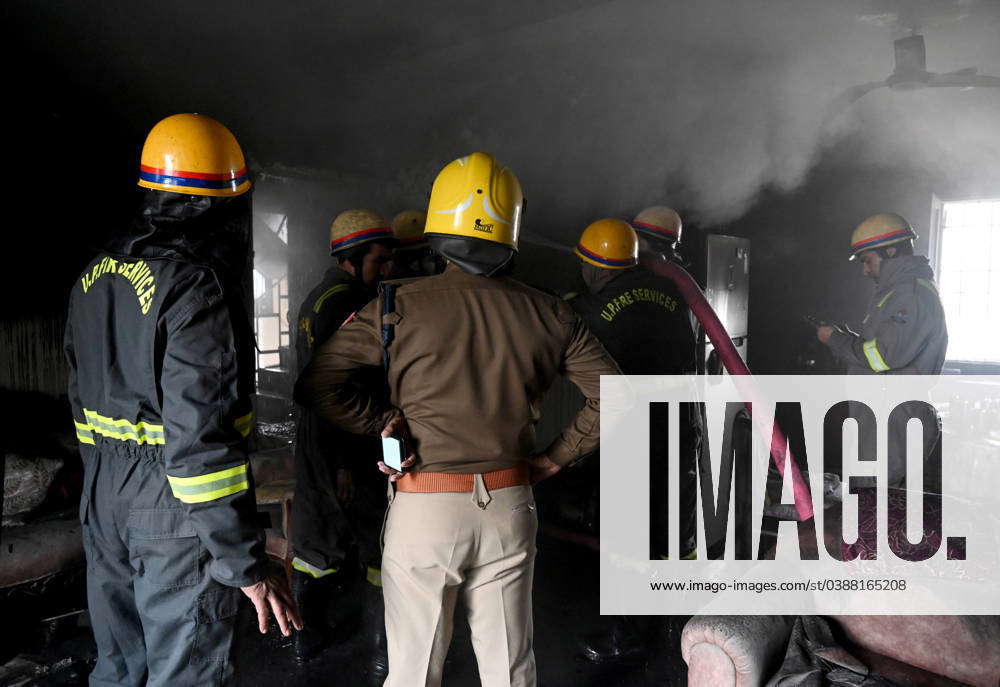 NOIDA, INDIA – JANUARY 14: A team of Firefighters trying to extinguish ...