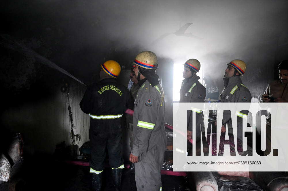 NOIDA, INDIA – JANUARY 14: A team of Firefighters trying to extinguish ...