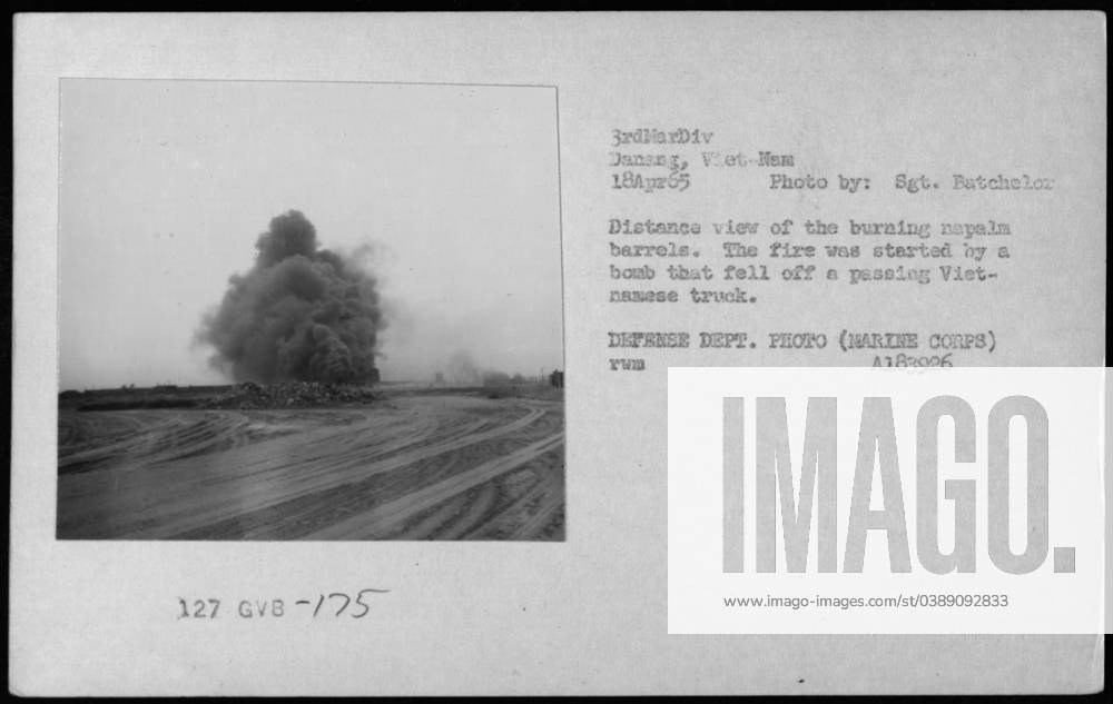 Distance view of burning napalm barrels caused by a bomb that fell off ...