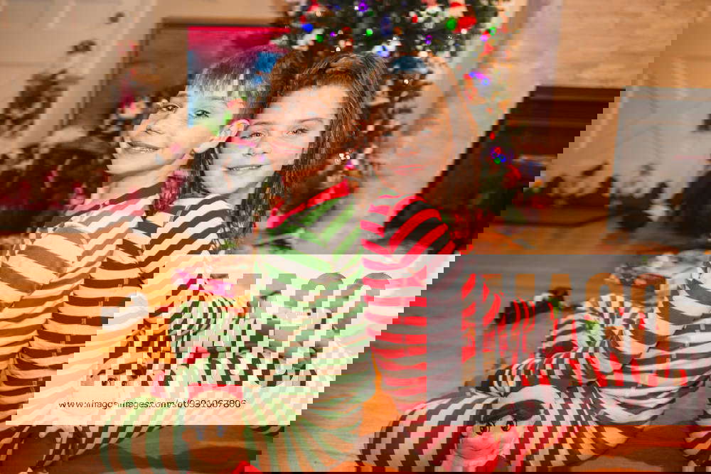 Twins goof around the christmas tree Long Branch, New Jersey, United States