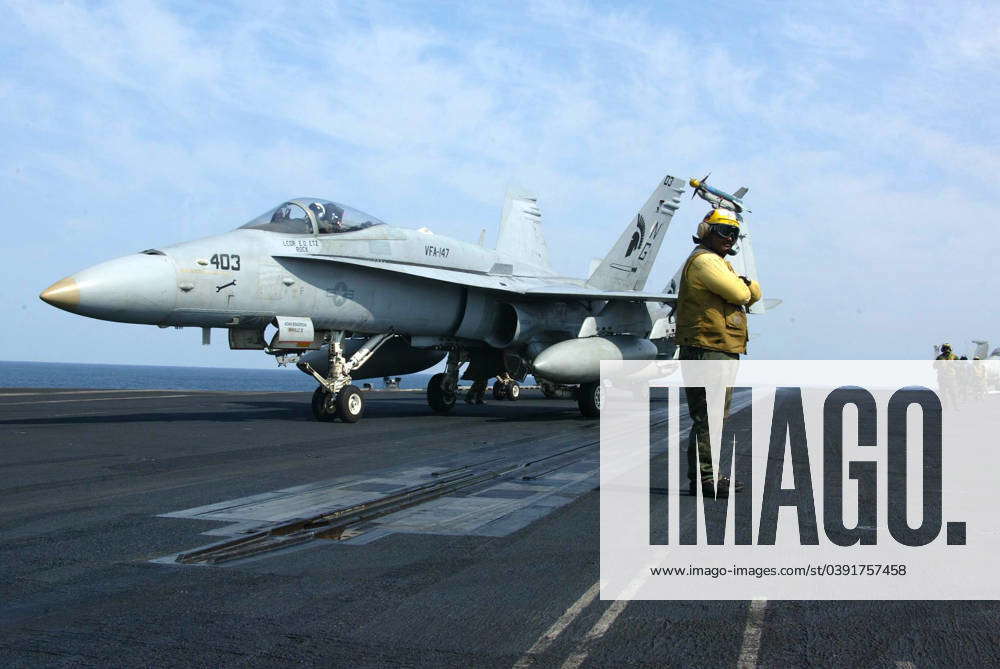 The catapult crew arrange the launch of a F A-18C Hornet on the flight ...