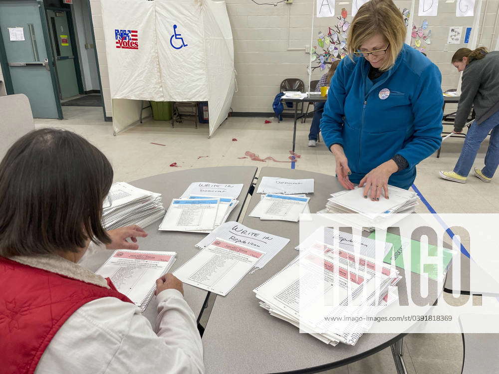 January 23, 2024, Nashua, New Hampshire, USA Election workers sort the