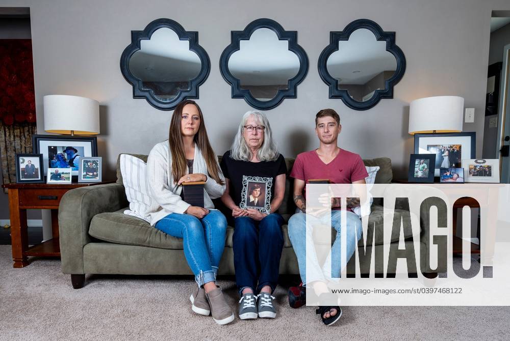 Syndication: Journal Sentinel (Center) Deborah Hoffmann holds a photo ...