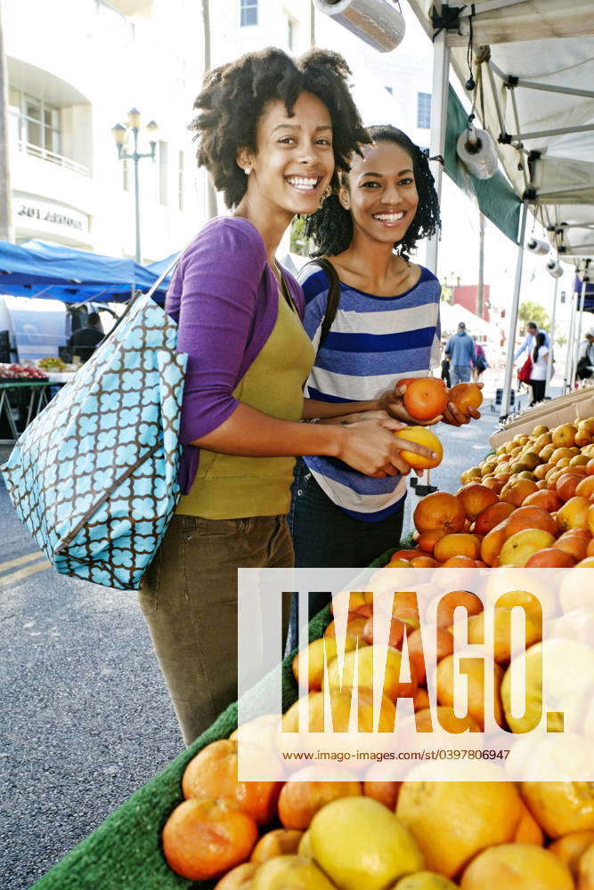 Women shopping together at fruit stand Los Angeles, California, USA, 16