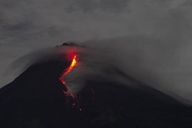 Mount Merapi Image Material Magelang, Central Java, Indonesia: Mount Merapi spews volcanic material ...