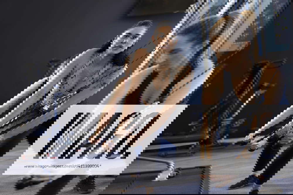 Woman using exercise equipment in gym Dallas Texas United States