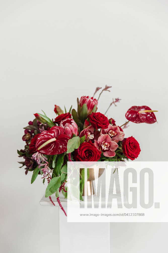 Vibrant Large Shades of Red Floral Arrangement in Gold Vase Edmonton