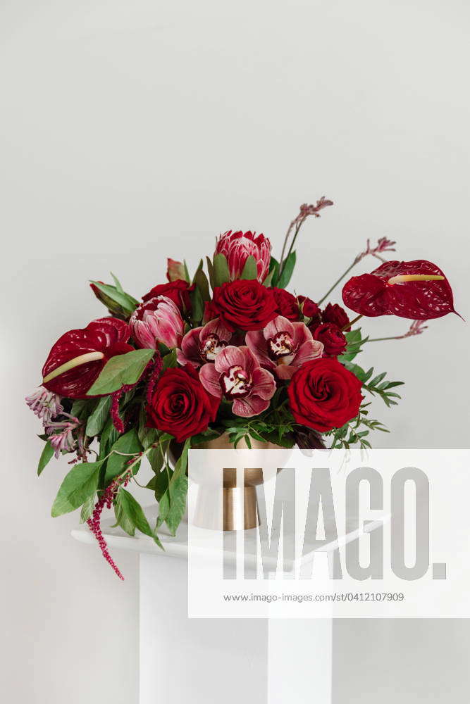 Vibrant Large Shades of Red Floral Arrangement in Gold Vase Edmonton