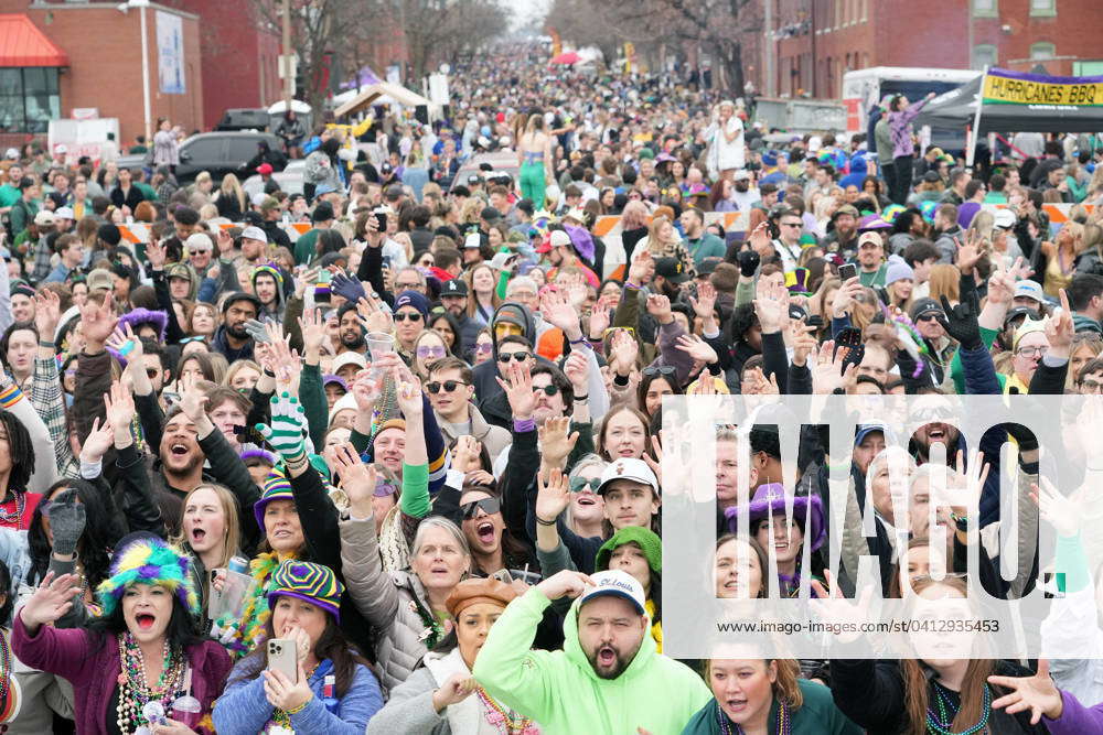 Parade goers line the parade route begging for beads while thousands ...