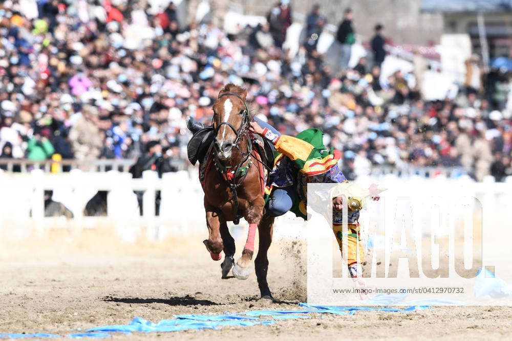 LHASA, CHINA - FEBRUARY 12: A rider performs hada (a traditional ...