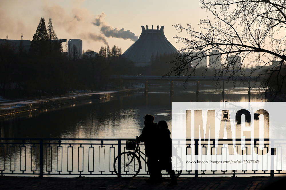 NORTH KOREA, PYONGYANG - FEBRUARY 9, 2024: People with a bicycle on a ...