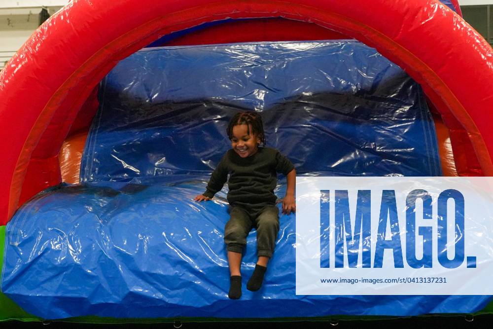 Syndication The Des Moines Register Karter Johnson, 3, smiles as he slides down the inflatable