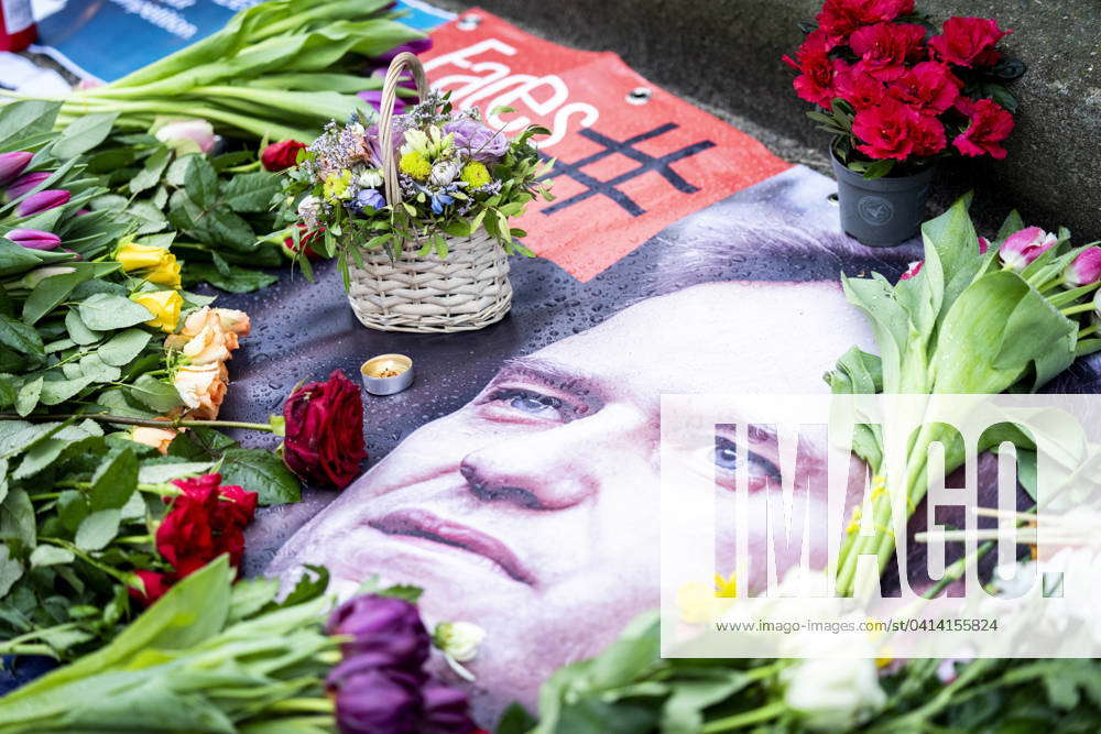 Flowers and a portrait of Russian opposition leader Alexei Navalny are ...