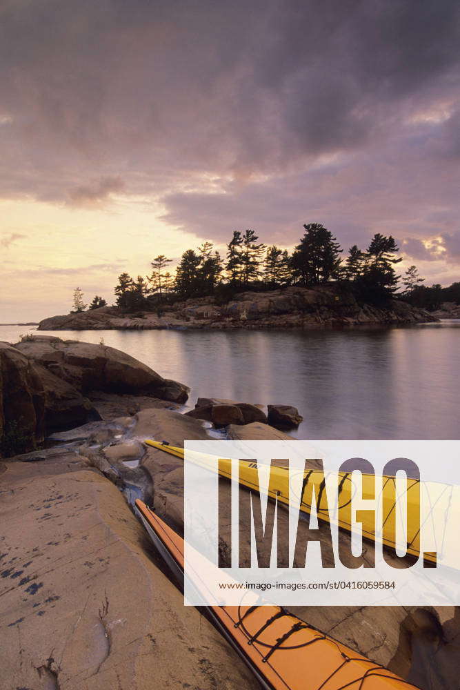 Kayaks on shore, Chikanishing Creek, sunset. Killarney Provincial Park ...