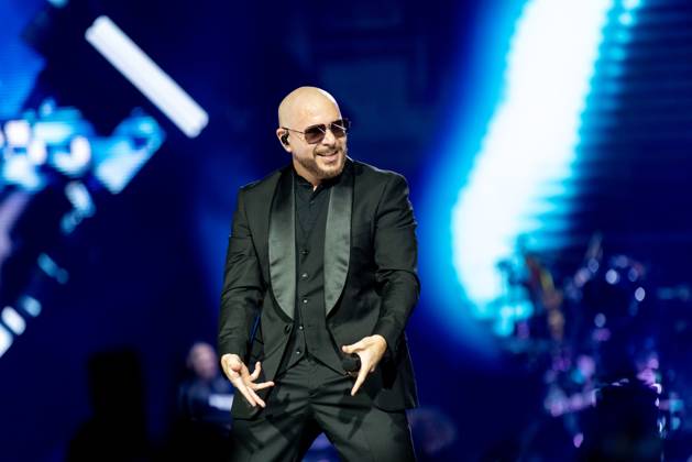 American hip hop and pop artist, Pitbull, performs on stage as part of ...