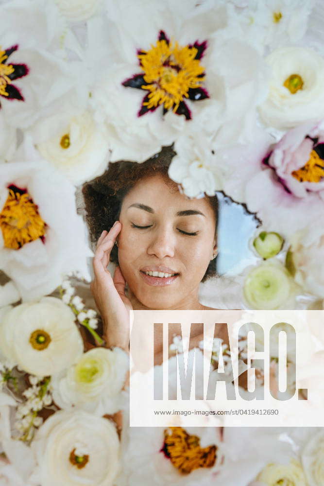 Young Woman With Eyes Closed Lying Under Glass Surface With Flowers Model Released Symbolfoto 1150